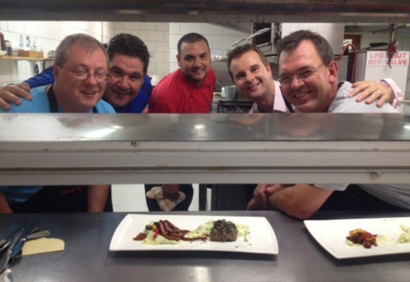 A team of gentlemen with Chef Ryan Brand at the MousterChef competition