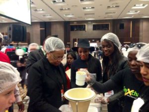 Graca Machel, Bonang Matheba and Joelle Kayembe helping pack food parcels at the Sandton Convention Centre for Stop Hunger Now on Mandela Day