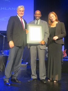 Tristan Kaatze (Group Director A& G Gaming) presents an award to Collins Mahlangu (Prive Ambassador) in acknowledgment of his 16 years of service. On the right is Annemie Turk (General Manager at Carnival City).