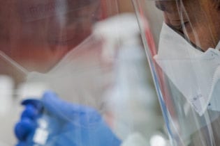 Pennsylvania Commonwealth microbiologist Kerry Pollard performs a manual extraction of the coronavirus inside the extraction lab at the Pennsylvania Department of Health Bureau of Laboratories on Friday, March 6, 2020.