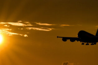 A plane flying past the sun