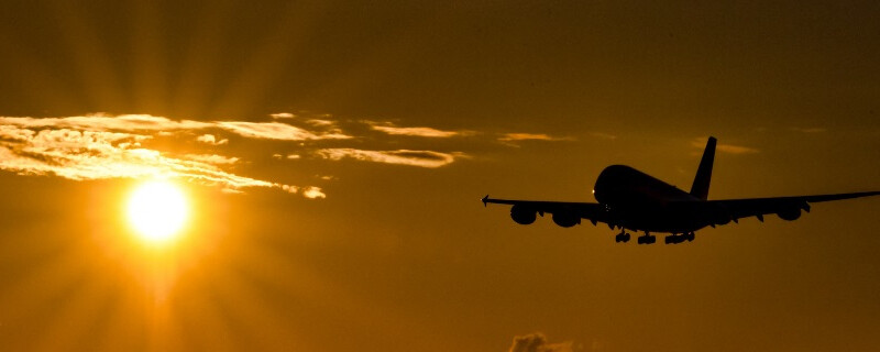 A plane flying past the sun