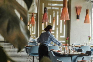 A waiter setting up tables in a restaurant