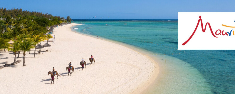 People riding horses on a beautiful white beach