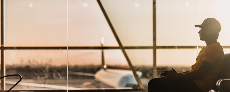 Tourist sitting in an airport - tourism safety cover image