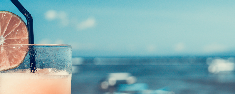 An orange cocktail on the beach