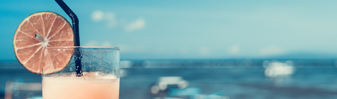 An orange cocktail on the beach