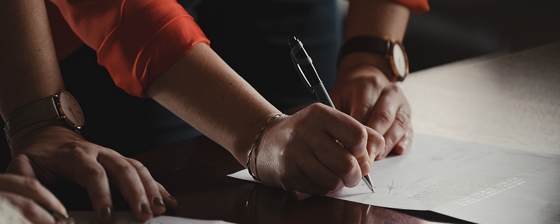 Stock photo of signing papers